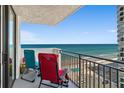 Relaxing condo balcony with seating offering panoramic ocean views and beach access at 2987 S Atlantic Ave # 901, Daytona Beach, FL 32118