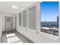 Bright condo hallway with natural light, gray wood floors, and views of the water at 2987 S Atlantic Ave # 901, Daytona Beach, FL 32118