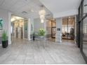 Modern lobby area with a chandelier, plants, and elevator access at 3043 S Atlantic Ave # A040, Daytona Beach, FL 32118