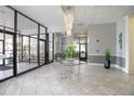 Bright lobby area featuring modern tile flooring, chandelier, and plants at 3043 S Atlantic Ave # A040, Daytona Beach, FL 32118