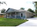 Charming, newly built single-Gathering home featuring a covered front porch, and attached two car garage at 349 Baker Ave, Lake Helen, FL 32744