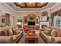 Cozy living room with fireplace, built-in shelving, comfortable sofas, creating an ideal space for relaxation and entertainment at 3592 Grande Tuscany Way, New Smyrna Beach, FL 32168