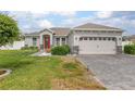 Lovely home showcasing a manicured lawn, paved driveway, and attractive architectural style at 413 Last Tree Dr, Deland, FL 32720
