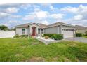 Beautiful single-Gathering home with a manicured lawn, driveway, and inviting exterior design at 413 Last Tree Dr, Deland, FL 32720