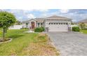 Inviting home with a well-kept lawn, paved driveway, and appealing architectural details at 413 Last Tree Dr, Deland, FL 32720