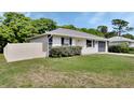 Single story home with green lawn and an attached one-car garage, enclosed by a vinyl fence at 414 Lancaster Ave, Orange City, FL 32763