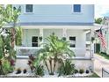 A cozy front porch with lush tropical landscaping and a view of the house number at 417 S Palmetto Ave, Daytona Beach, FL 32114