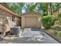 Detached garage with wooden ramp and siding that complements the exterior of the main house at 535 Black Ironwood Dr, Deland, FL 32724