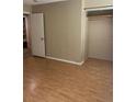A neutral-toned bedroom features laminate flooring and a closet for storage, offering a clean and simple aesthetic at 621 W Indiana Ave # 13, Deland, FL 32720