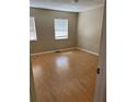 Bright bedroom with laminate floors and natural light from two windows offers a comfortable and airy space at 621 W Indiana Ave # 13, Deland, FL 32720