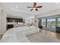 Open-concept living room with a modern kitchen, dining area, and access to an outdoor patio at 6871 Forkmead Ln, Port Orange, FL 32128