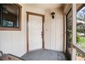 View of the front door from inside the screened porch area at 71 Crooked Pine Rd, Port Orange, FL 32128