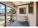 Relaxing screened front porch with a hanging swing to sit and enjoy the outdoors at 71 Crooked Pine Rd, Port Orange, FL 32128