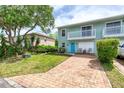 Attractive two-story townhouse with a balcony, brick driveway, and healthy green lawn at 721 Laurel Bay Cir, New Smyrna Beach, FL 32169