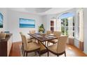 Bright dining room featuring a wooden table, six chairs, and large windows with elegant curtains at 802 Royal Oak Ct, Deland, FL 32724