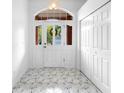 Bright entryway with marble floors, a glass-paneled front door, and a coat closet at 802 Royal Oak Ct, Deland, FL 32724