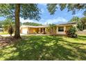 Charming home exterior with a lush green lawn, mature trees, and inviting curb appeal at 833 Lucerne Cir, Ormond Beach, FL 32174