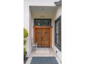 Close-up of elegant double front doors with beautiful wood craftsmanship and decorative tile entry at 940 Glenwood Rd, Deland, FL 32720