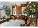 Unique living room showcasing wood paneling, a large arched window, and eclectic décor at 940 Glenwood Rd, Deland, FL 32720