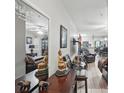 Inviting living room with elegant decor, wood floors, and a view into the dining area at 944 Regatta Bay Dr # 12-102, Orange City, FL 32763
