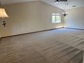 Expansive living room featuring vaulted ceilings and ample natural light from large windows at 96 Old Barn Trl, Ormond Beach, FL 32174