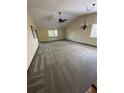 Open living room with vaulted ceilings and neutral carpeting, awaiting your personal touch at 96 Old Barn Trl, Ormond Beach, FL 32174