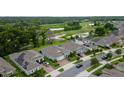 Aerial view of homes in a community, showcasing lush greenery, ponds, and a glimpse of a golf course at 978 Victoria Hills S Dr, Deland, FL 32724