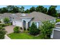 Beautiful single-story home with a three-car garage, brick paver driveway, and lovely landscaping at 978 Victoria Hills S Dr, Deland, FL 32724