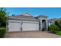 Beautiful home with a three-car garage, paver driveway, stone accents, and neat landscaping at 978 Victoria Hills S Dr, Deland, FL 32724