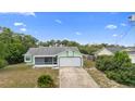 Ariel view of a single story home with screened-in porch and mature trees at 1018 E Gaucho Cir, Deltona, FL 32725