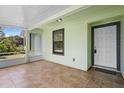Screened-in porch featuring a tiled floor and exterior door to the home at 1018 E Gaucho Cir, Deltona, FL 32725