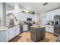 Bright kitchen with stainless steel appliances, an island, and lots of cabinet space at 1205 Weeping Willow Dr, Deland, FL 32724