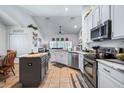 Bright kitchen with stainless steel appliances, an island, and lots of cabinet space at 1205 Weeping Willow Dr, Deland, FL 32724