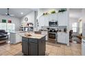 Bright kitchen with stainless steel appliances, an island, and lots of cabinet space at 1205 Weeping Willow Dr, Deland, FL 32724