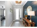 Inviting foyer with stylish decor, a wooden console table, and a view into other rooms at 1227 Victoria Hills N Dr, Deland, FL 32724