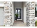 Close-up of the home's front door with stone pillars and decorative plants at 1227 Victoria Hills N Dr, Deland, FL 32724