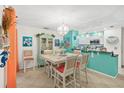 Bright dining area with charming china cabinet, chandelier, adjacent to a cozy kitchen space at 127 Cypress Pond Rd, Port Orange, FL 32128