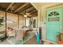 Inviting porch with wicker furniture, coastal decor, and ceiling fan for relaxed outdoor seating at 127 Cypress Pond Rd, Port Orange, FL 32128