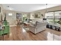 Bright living room with hardwood floors, comfortable seating, large windows, and a stylish area rug at 1310 Pup Fish Ln, Deland, FL 32724