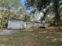 A single-Gathering home featuring an attached one-car garage and a front yard with mature trees at 1370 19Th St, Orange City, FL 32763