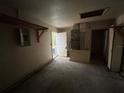An empty garage with a rear entry door, an electrical panel, and exposed utilities at 1370 19Th St, Orange City, FL 32763