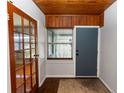 Foyer featuring a wooden ceiling, beautiful flooring, wood-trimmed glass doors, and access to additional rooms at 18 S Shell Rd, Debary, FL 32713