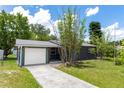 Charming one-story home with a well-maintained lawn, mature bamboo, and attached garage with a private fenced entrance at 18 S Shell Rd, Debary, FL 32713
