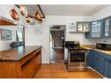 Open kitchen with stainless steel appliances, wooden countertops, pot rack, custom cabinets, and a breakfast nook at 18 S Shell Rd, Debary, FL 32713