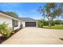 Lovely single-story home features a spacious driveway and a well-maintained lawn with mature trees at 185 Brookside Dr, Port Orange, FL 32128