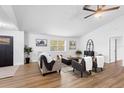 Bright living room featuring wood floors, neutral furniture, and a large window offering plenty of natural light at 185 Brookside Dr, Port Orange, FL 32128