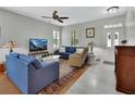 Inviting living area with tile and hardwood flooring, featuring a cozy seating arrangement and natural light at 202 W Chancery Ln, Deland, FL 32724