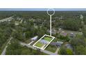 Aerial view showcasing the property, its surroundings, mature trees and neighborhood layout at 2127 3Rd Ave, Deland, FL 32724