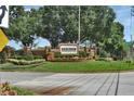 Debary Golf & Country Club entrance with brick signage, lush landscaping, and manicured grounds at 217 Lourdan Ct, Debary, FL 32713