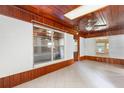 Bright living room featuring a wooden ceiling, white brick walls, tile flooring, and large windows at 220 N Julia Ave, Deland, FL 32720